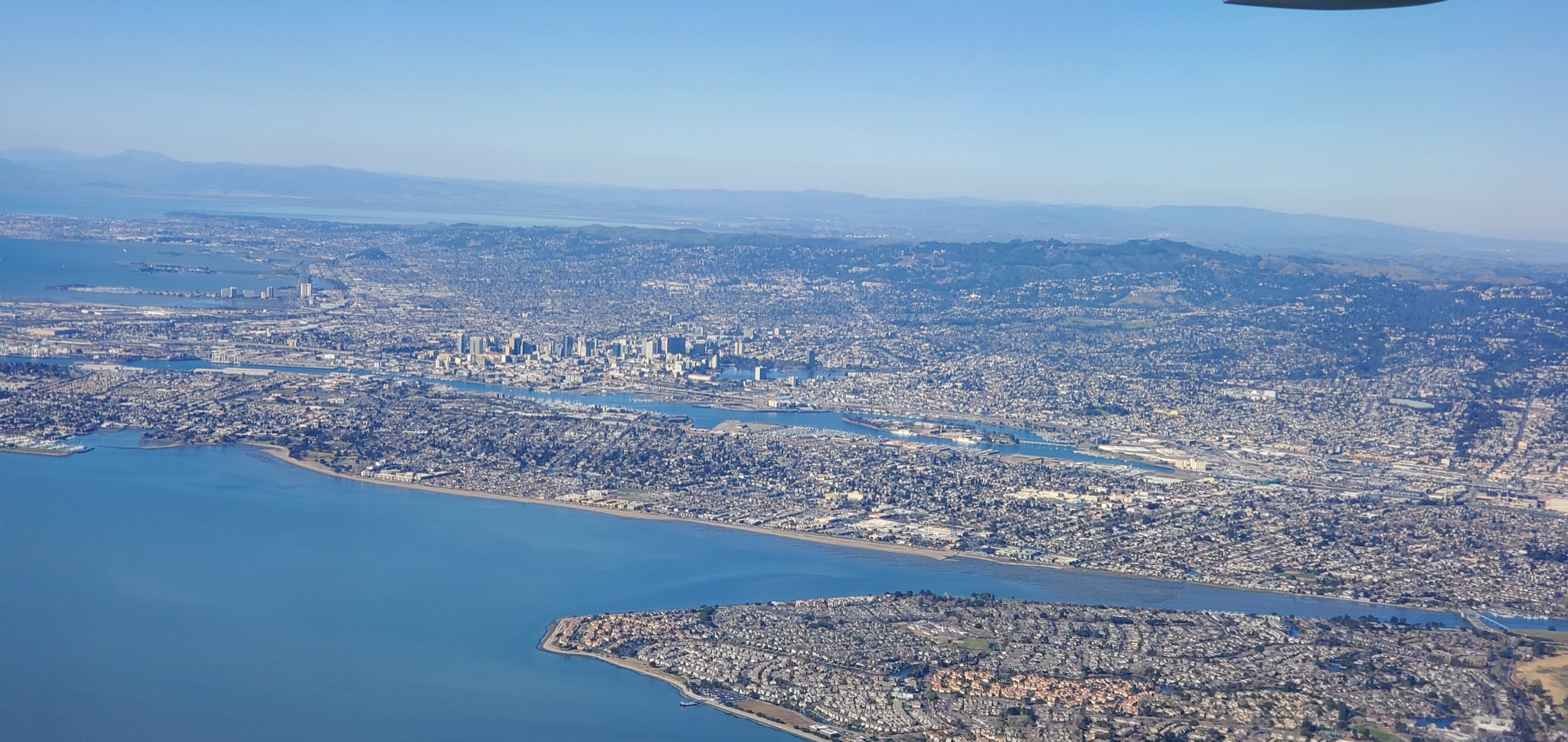Aerial view of Alameda and the Oakland skyline along San Francisco Bay.