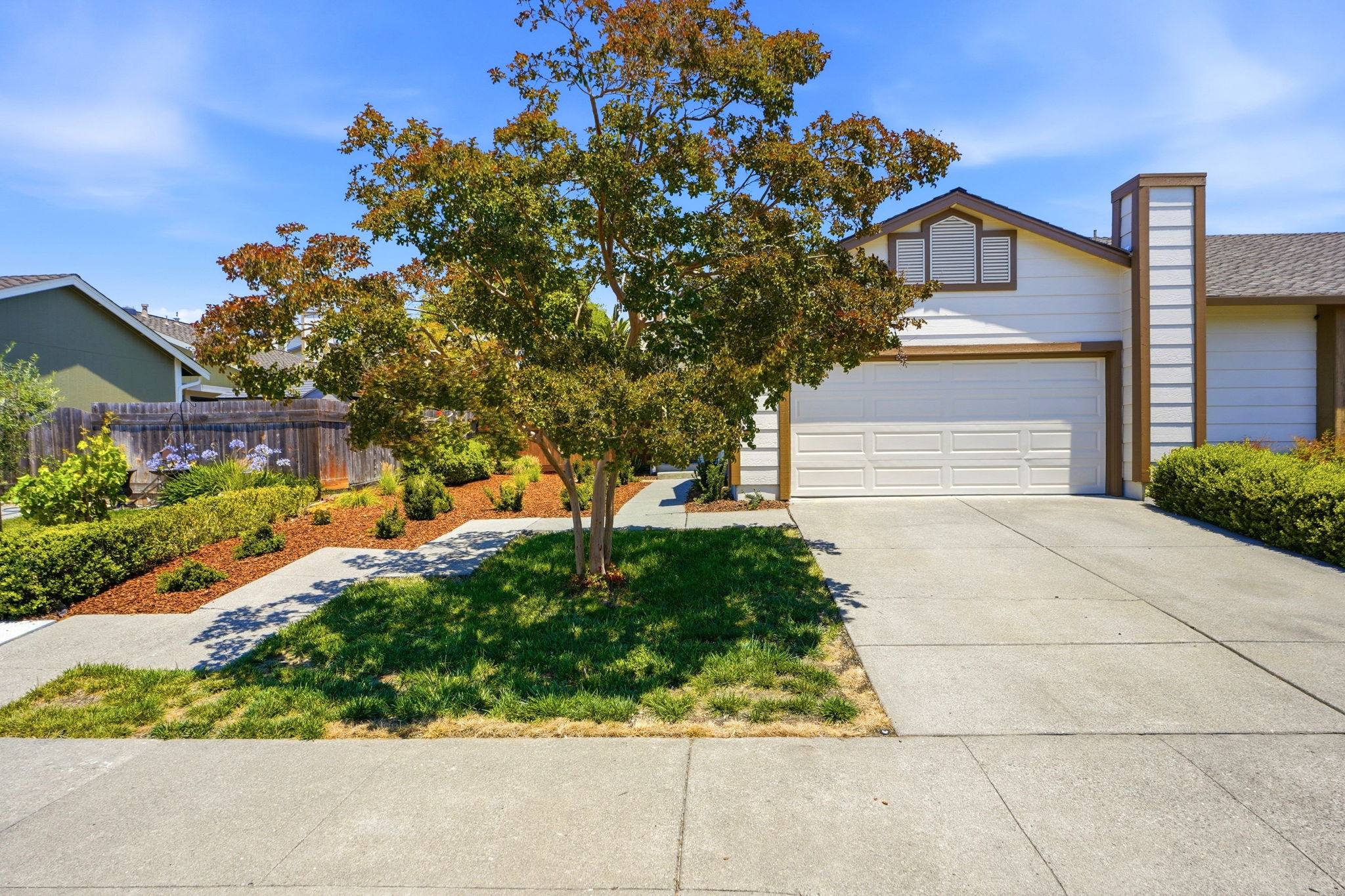 A Bay Vista–managed two-story home with a white garage and tidy front landscaping.