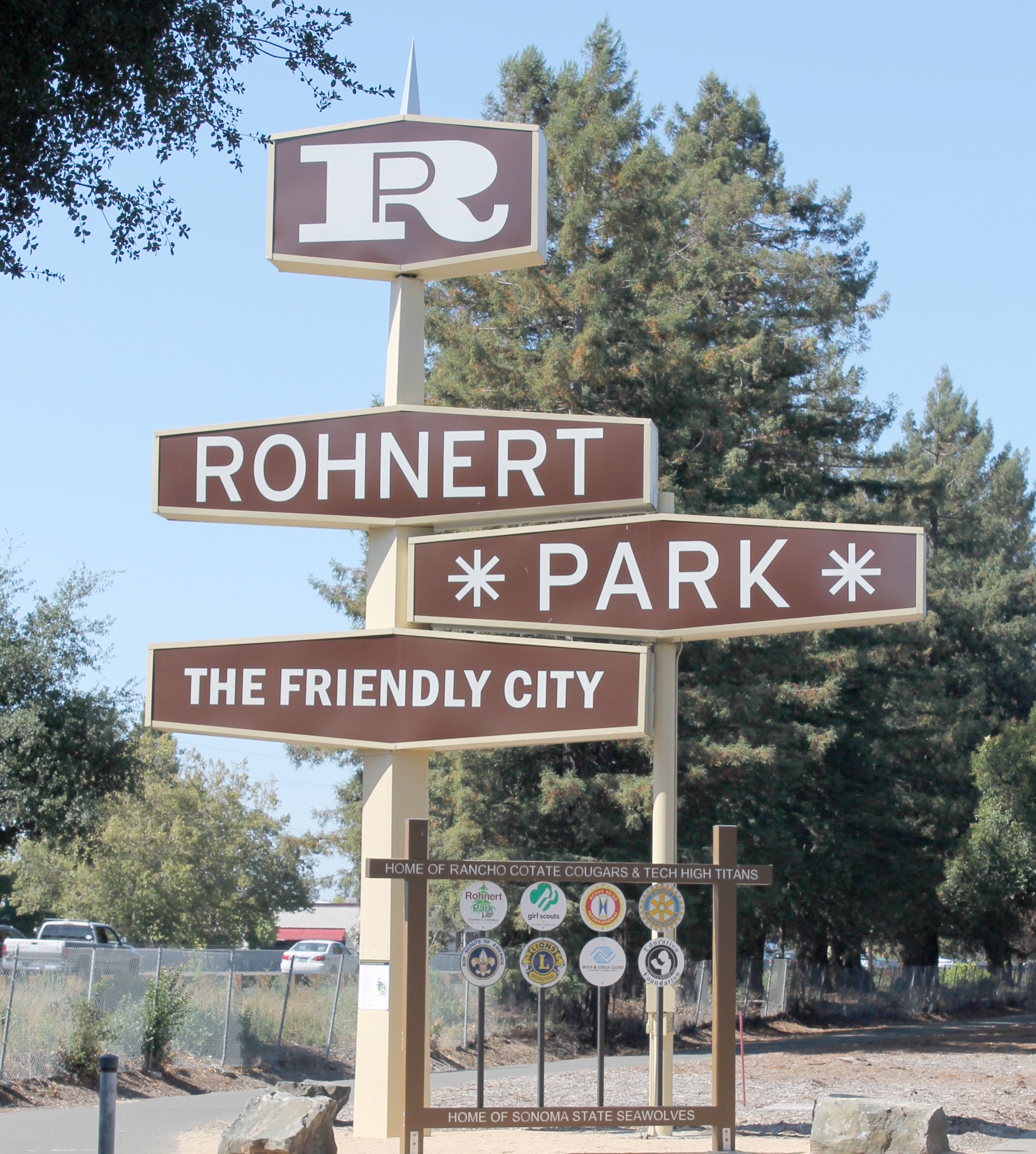 The Rohnert Park welcome sign, The Friendly City, with redwoods behind.