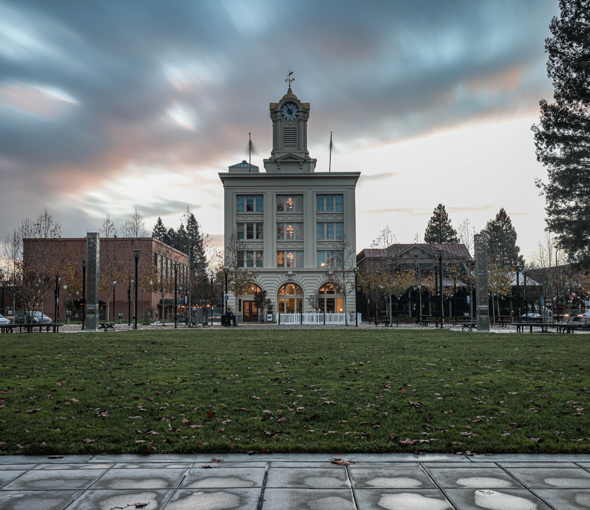 The Empire Building clock tower on Old Courthouse Square in downtown Santa Rosa at dusk.